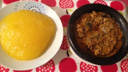 A plate of starch and banga soup - typical lunch in Southern Nigeria.